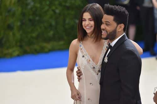 Selena Gomez (L) and The Weeknd attend the