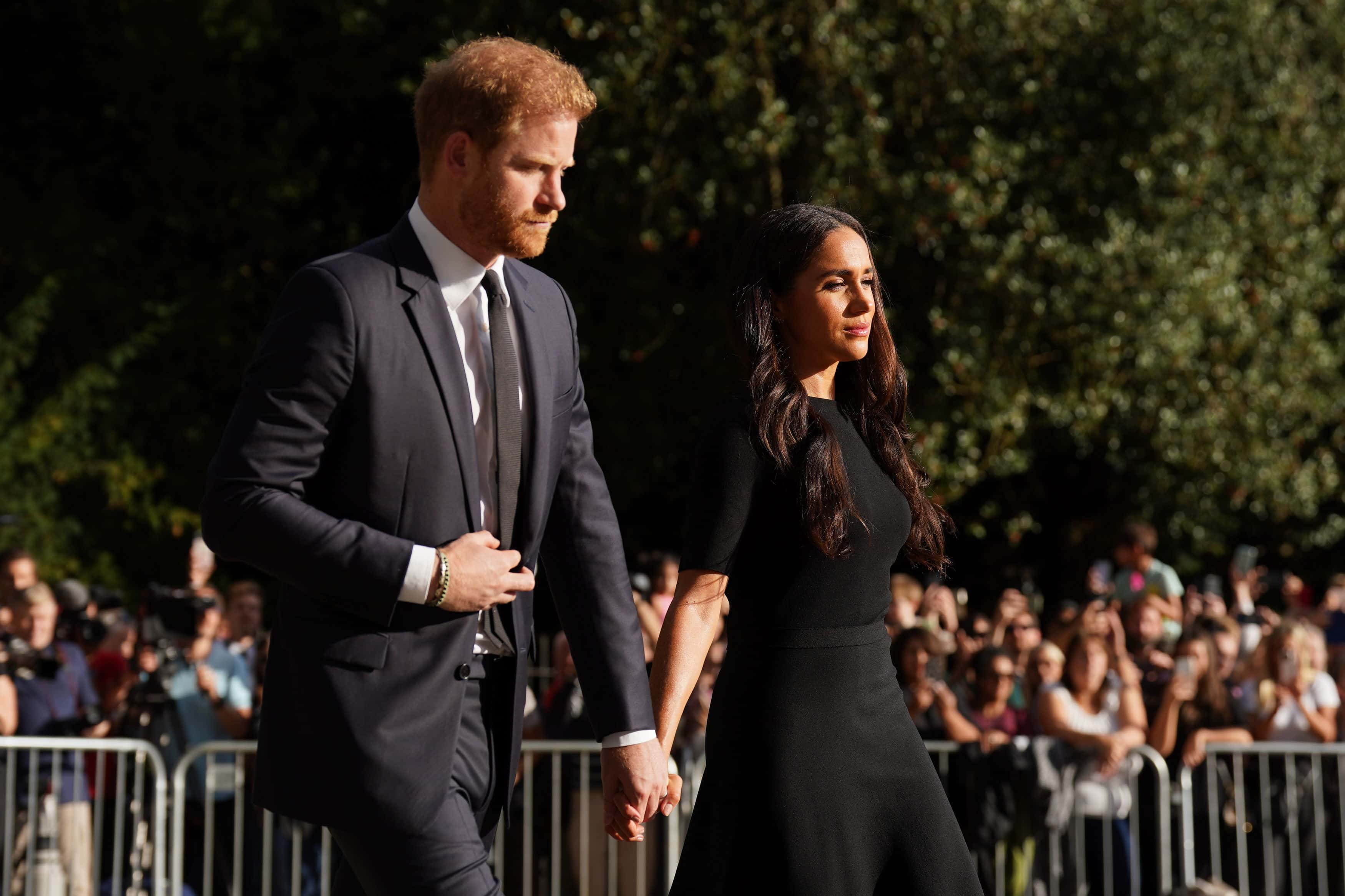 Meghan, Duchess of Sussex and Prince Harry, Duke of Sussex meet members of the public at Windsor Castle on September 10, 2022 in Windsor, England. Crowds have gathered and tributes left at the gates of Windsor Castle to Queen Elizabeth II, who died at Balmoral Castle on 8 September, 2022.