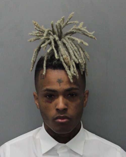 (EDITOR'S NOTE: Best quality available)  In this handout provided by the Miami Dade County Corrections, Rapper XXXTentacion, also known as Jahseh Dwayne Onfroy poses for his mugshot after being charged with seven new felonies stemming from a 2016 domestic violence case on December 15, 2017 in Miami, Florida. The new charges are for witness tampering and harassment.