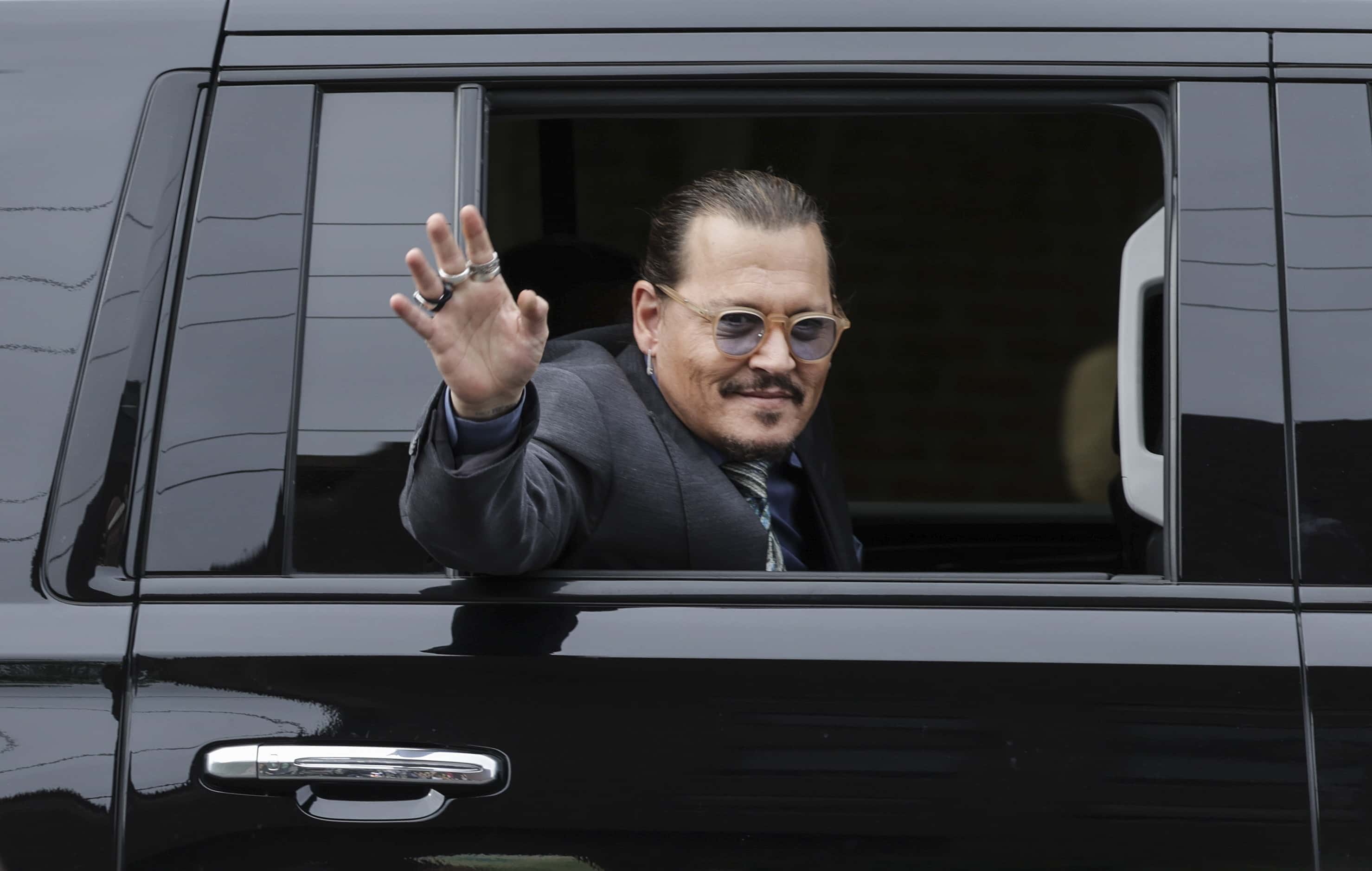 Actor Johnny Depp waves to supporters as he leaves the Fairfax County Courthouse on May 25, 2022 in Fairfax, Virginia. The Depp v. Heard, a defamation trial brought by Johnny Depp against his ex-wife Amber Heard is in its last week of trial with closing argument scheduled on this Friday.
