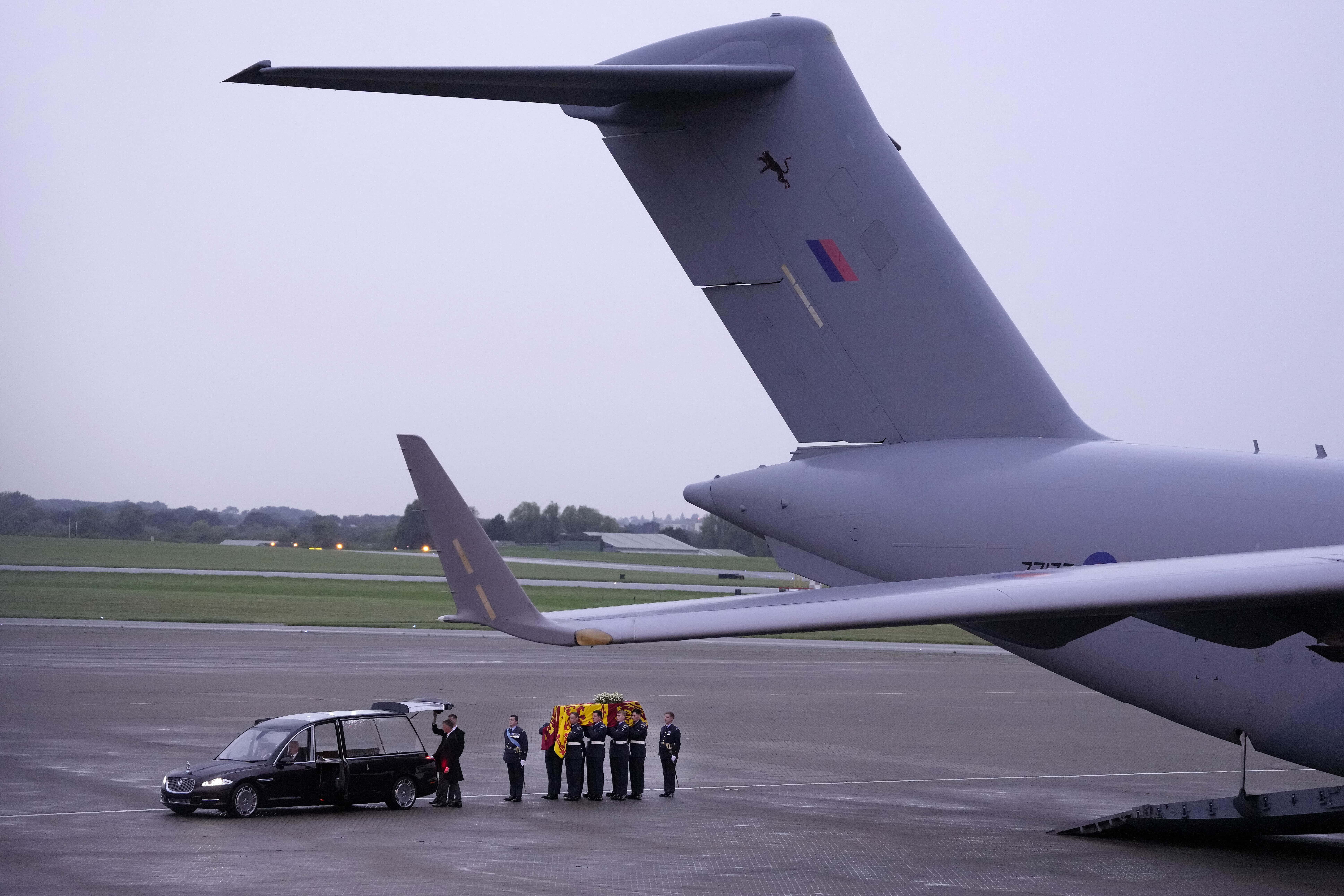 The coffin of Queen Elizabeth II is carried off a plane by the Queen's Colour Squadron and lifted into the state hearse at RAF Northolt, west London, from where it will be taken to Buckingham Palace, London, to lie at rest overnight in the Bow Room on September 13, 2022 in London, England. The coffin carrying Her Majesty Queen Elizabeth II leaves St Giles Church travelling to Edinburgh Airport where it will be flown to London and transferred to Buckingham Palace by road. Queen Elizabeth II died at Balmoral Castle in Scotland on September 8, 2022, and is succeeded by her eldest son, King Charles III.
