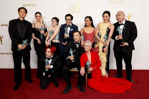 (L-R) Harry Shum Jr., Jenny Slate, Andy Le, Tallie Medel, Ke Huy Quan, James Hong, Stephanie Hsu, Jamie Lee Curtis, Michelle Yeoh and Brian Le, recipients of the Outstanding Performance by a Cast in a Motion Picture award for