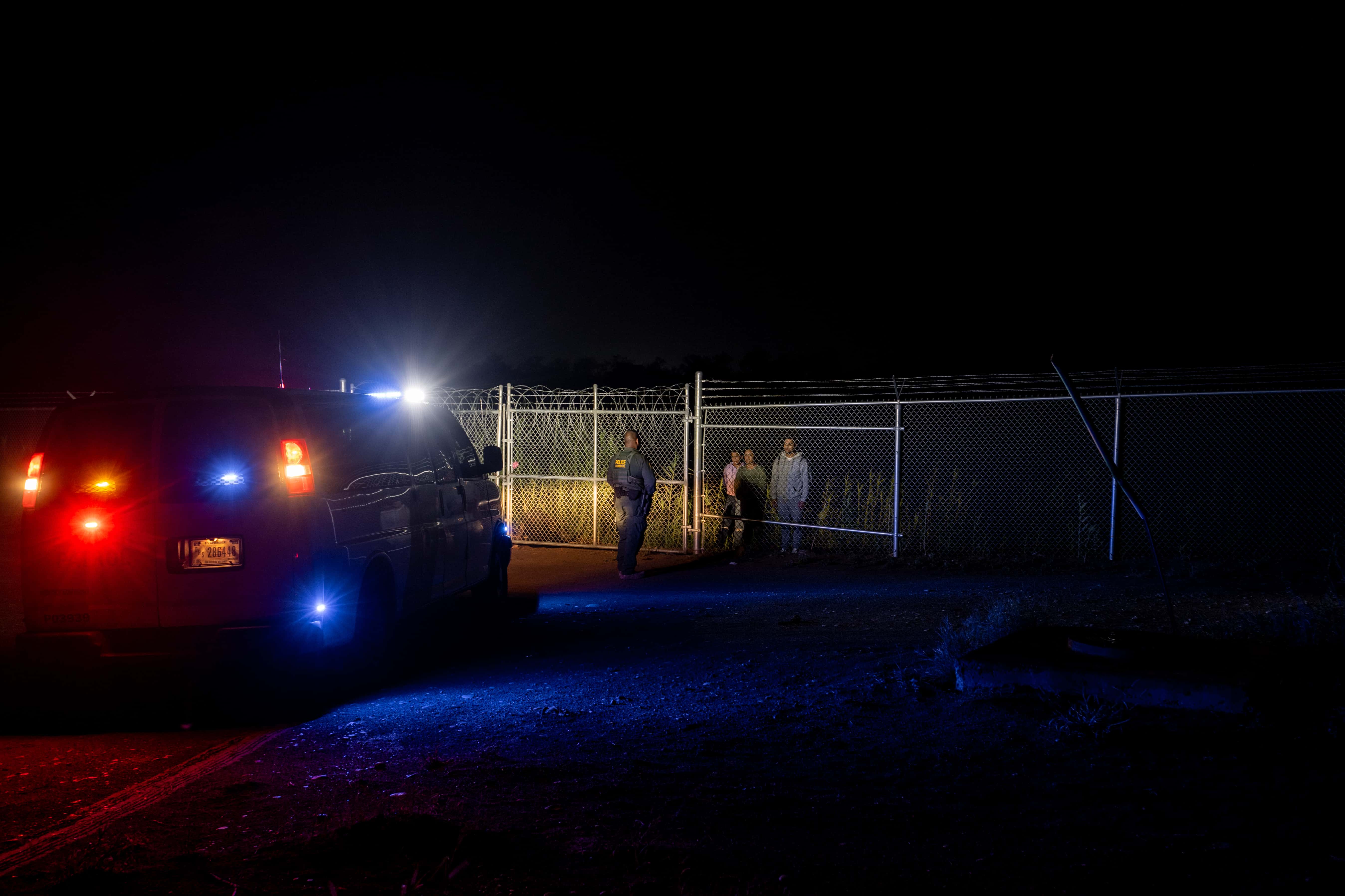 A Border Patrol officer speaks to migrants from Colombia, before opening the gate, after they crossed the Rio Grande into the U.S. on May 22, 2022 in Eagle Pass, Texas. Title 42, the controversial pandemic-era border policy enacted by former President Trump, which cites COVID-19 as the reason to rapidly expel asylum seekers at the U.S. border, was set to officially expire on May 23rd. A federal judge in Louisiana delivered a ruling blocking the Biden administration from lifting Title 42.
