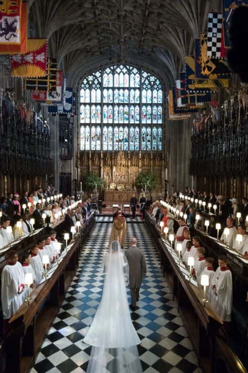 Meghan Markle walks up the aisle with the Prince Charles, Prince of Wales at St George's Chapel at Windsor Castle during her wedding to Prince Harry on May 19, 2018 in Windsor, England..