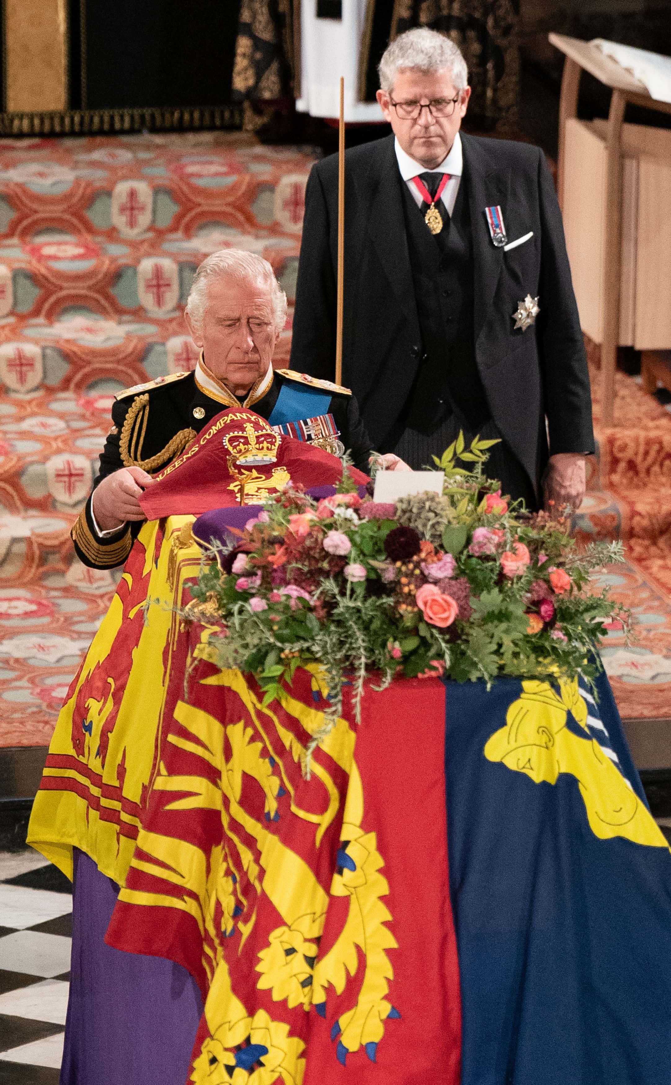 King Charles III places the Queen's Company Camp Colour of the Grenadier Guards on the coffin during the Committal Service at St George's Chapel in Windsor Castle on September 19, 2022 in Windsor, England. The committal service at St George's Chapel, Windsor Castle, took place following the state funeral at Westminster Abbey. A private burial in The King George VI Memorial Chapel followed. Queen Elizabeth II died at Balmoral Castle in Scotland on September 8, 2022, and is succeeded by her eldest son, King Charles III.