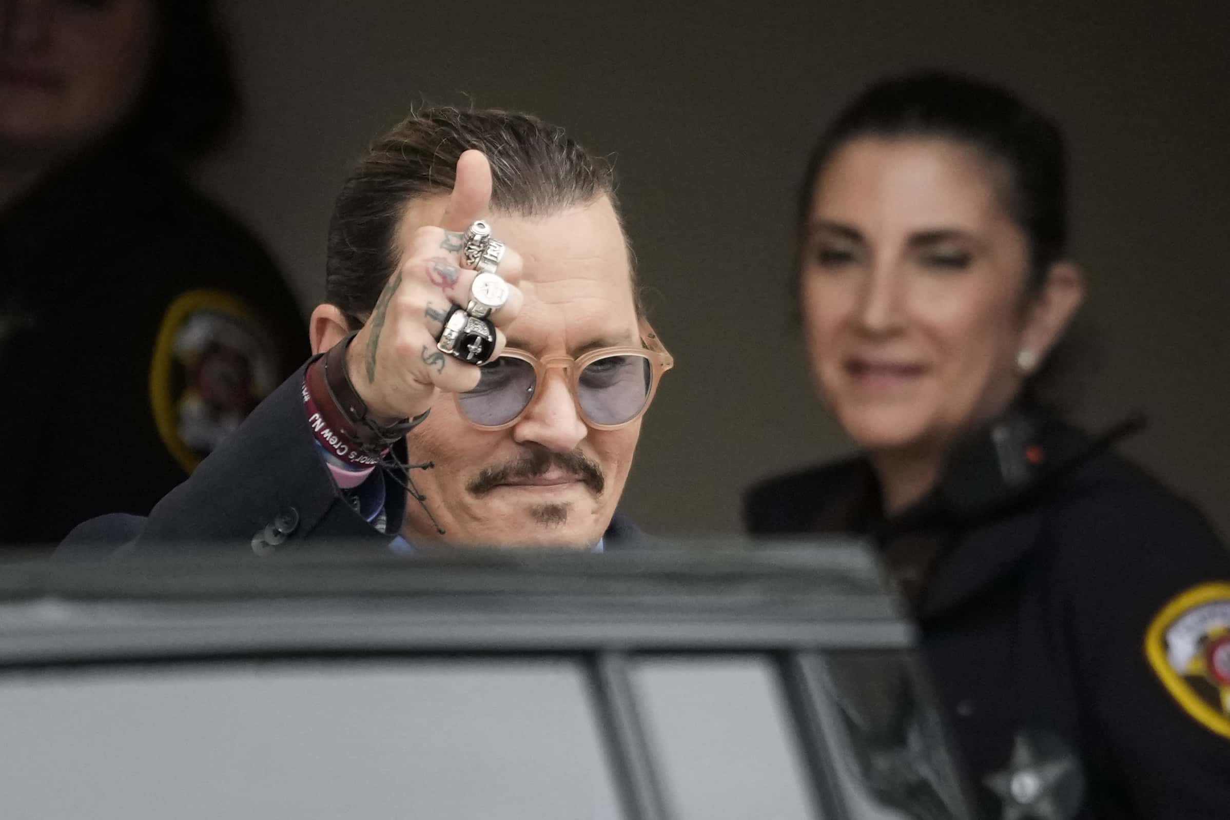Actor Johnny Depp gives a thumbs up toward fans as he departs the Fairfax County Courthouse on May 27, 2022 in Fairfax, Virginia. Closing arguments in the Depp v. Heard defamation trial, brought by Johnny Depp against his ex-wife Amber Heard, concluded today and jury deliberations begin.