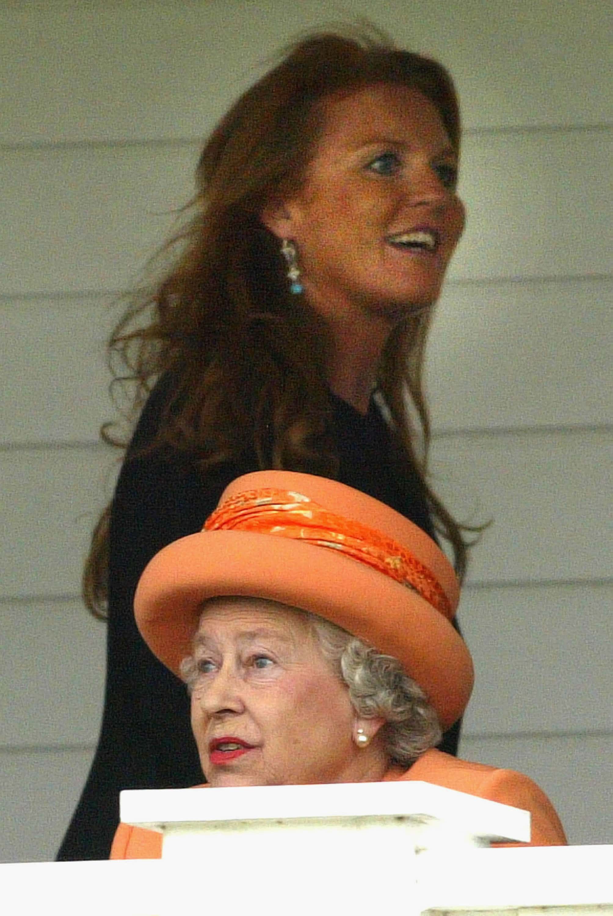 Sarah Ferguson, the Duchess of York, passes Queen Elizabeth II as she spectates at the Guards Polo Club on July 25, 2004 in Windsor, England.