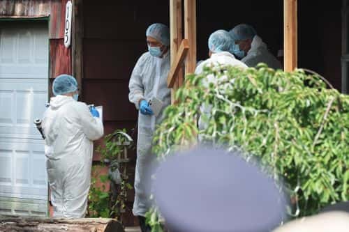 Law enforcement officials are seen as they investigate the home of a suspect arrested in the unsolved Gilgo Beach killings on July 14, 2023 in Massapequa Park, New York. A suspect in the Gilgo Beach killings was arrested in the unsolved case tied to at least 10 sets of human remains that were discovered since 2010 in suburban Long Island. The suspect Rex Heuermann is expected to be arraigned after his arrest Thursday night. A grand jury charged Heurmann with six counts of murder. The charges stem from the deaths of three of the four 