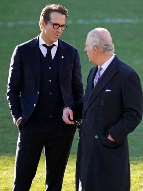 King Charles III talks to Co-Owner Wrexham AFC Ryan Reynolds (L) during their visit to Wrexham AFC on December 09, 2022 in Wrexham, Wales. Formed in 1864, Wrexham AFC is the third oldest professional football team in the world. The club was taken over by Hollywood actors Ryan Reynolds and Rob McElhenney in late 2020.