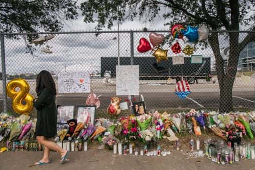 A woman walks past a memorial to those who died at the Astroworld festival outside of NRG Park on November 09, 2021 in Houston, Texas. Eight people were killed and dozens injured last Friday in a crowd surge during a Travis Scott concert at the Astroworld music festival. Several lawsuits have been filed against Scott, and authorities continue investigations around the event. Scott, a Houston-native rapper and musician, launched the festival in 2018.