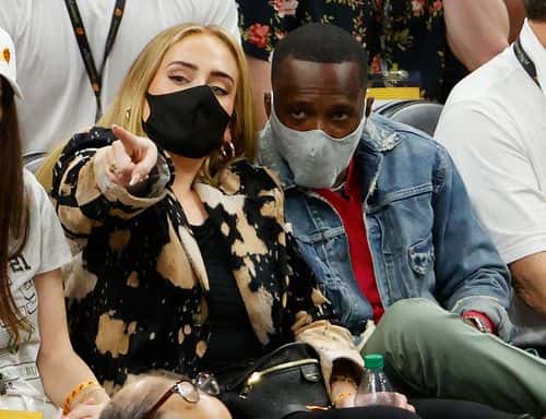 Singer Adele looks on next to Rich Paul during the first half in Game Five of the NBA Finals between the Milwaukee Bucks and the Phoenix Suns at Footprint Center on July 17, 2021 in Phoenix, Arizona. NOTE TO USER: User expressly acknowledges and agrees that, by downloading and or using this photograph, User is consenting to the terms and conditions of the Getty Images License Agreement.