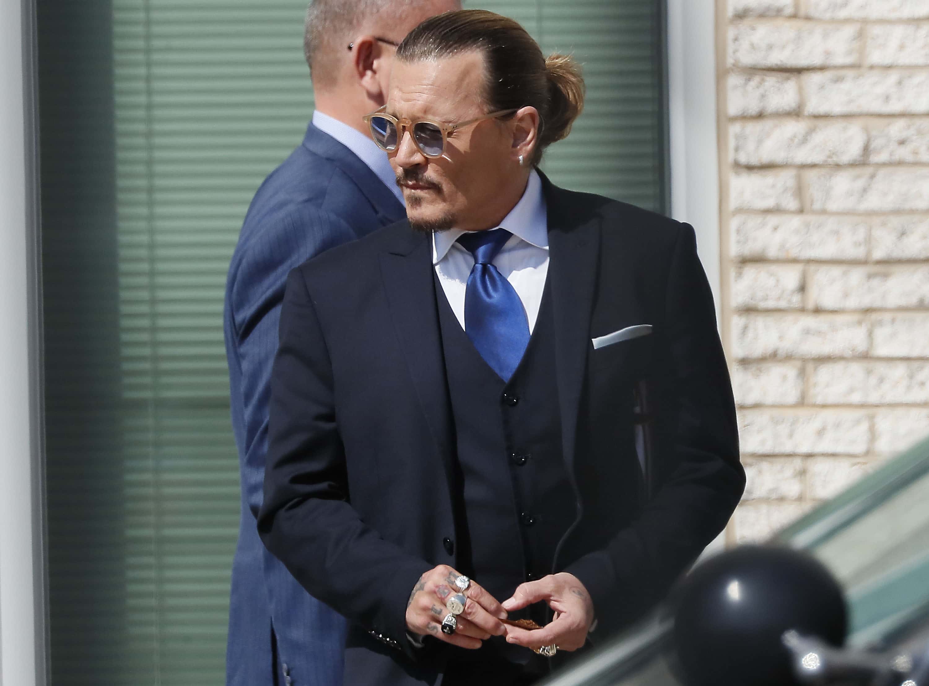Johnny Depp steps outside court during his civil trial at Fairfax County Circuit Court on April 25, 2022 in Fairfax, Virginia. Depp is seeking $50 million in alleged damages to his career over an op-ed Heard wrote in the Washington Post in 2018.