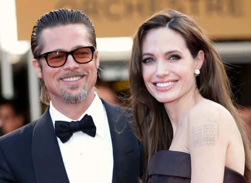 Angelina Jolie (R) and Brad Pitt attend