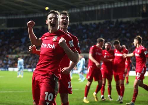 Paul Mullin of Wrexham celebrates after Thomas O'Connor of Wrexham celebrates scores his teams third goal during the Emirates FA Cup Third Round match between Coventry City and Wrexham at The Coventry Building Society Arena on January 07, 2023 in Coventry, England.