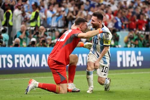 Emiliano Martinez and Lionel Messi of Argentina celebrate after the team's victory in the penalty shoot out  during the FIFA World Cup Qatar 2022 quarter final match between Netherlands and Argentina at Lusail Stadium on December 09, 2022 in Lusail City, Qatar.